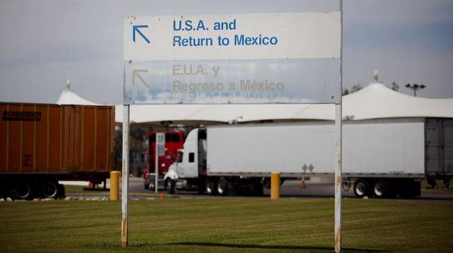 Border-crossing trucks and sign