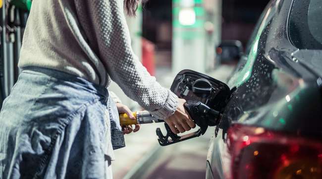 Woman pumping gasoline