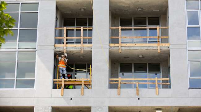 A contractor works during construction of a new apartment building in downtown Seattle.